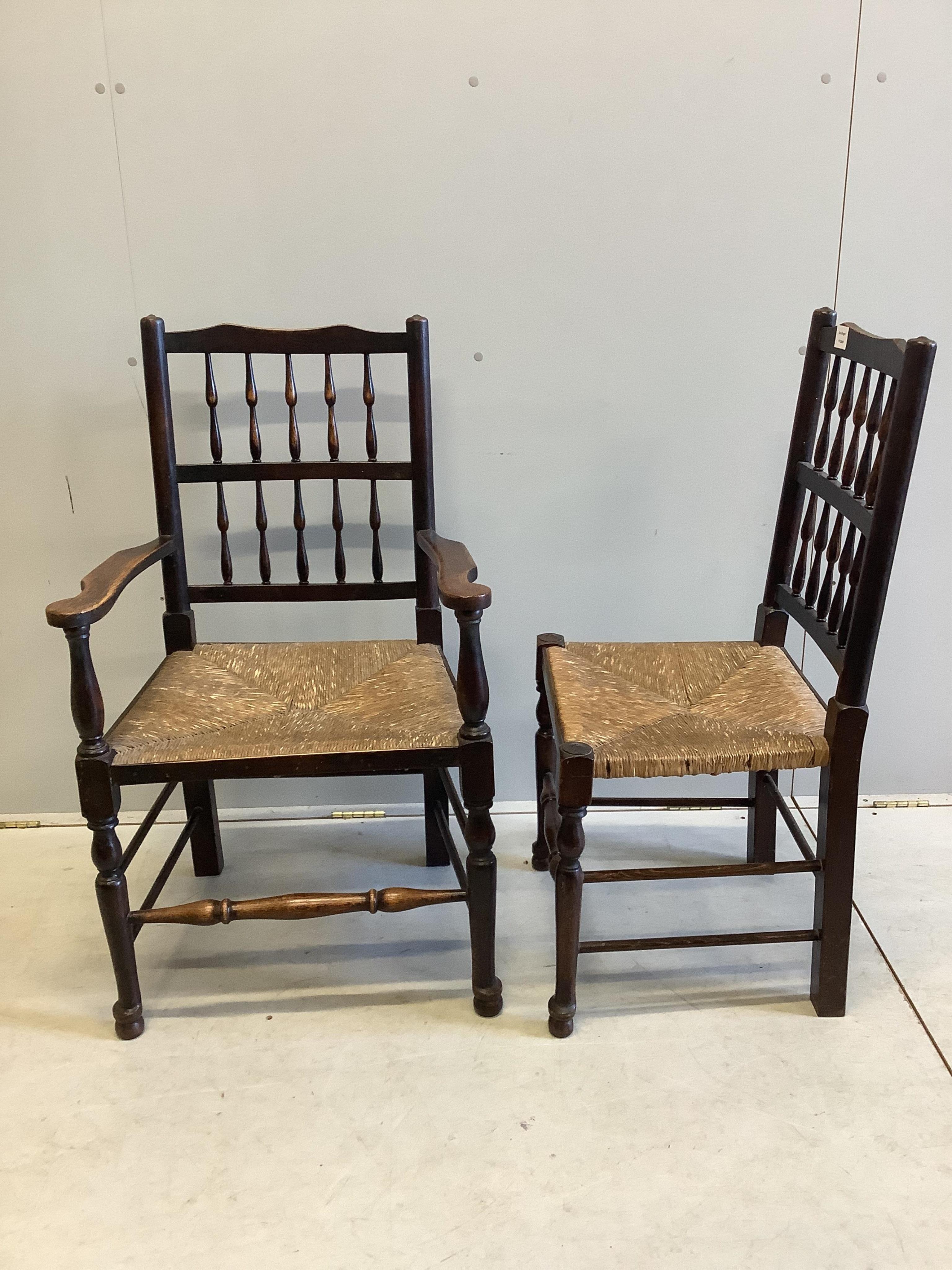 A set of ten ash spindle back chairs, two with arms. Condition - fair